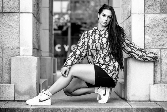 Woman with cool top, sneakers, and black athletic shorts