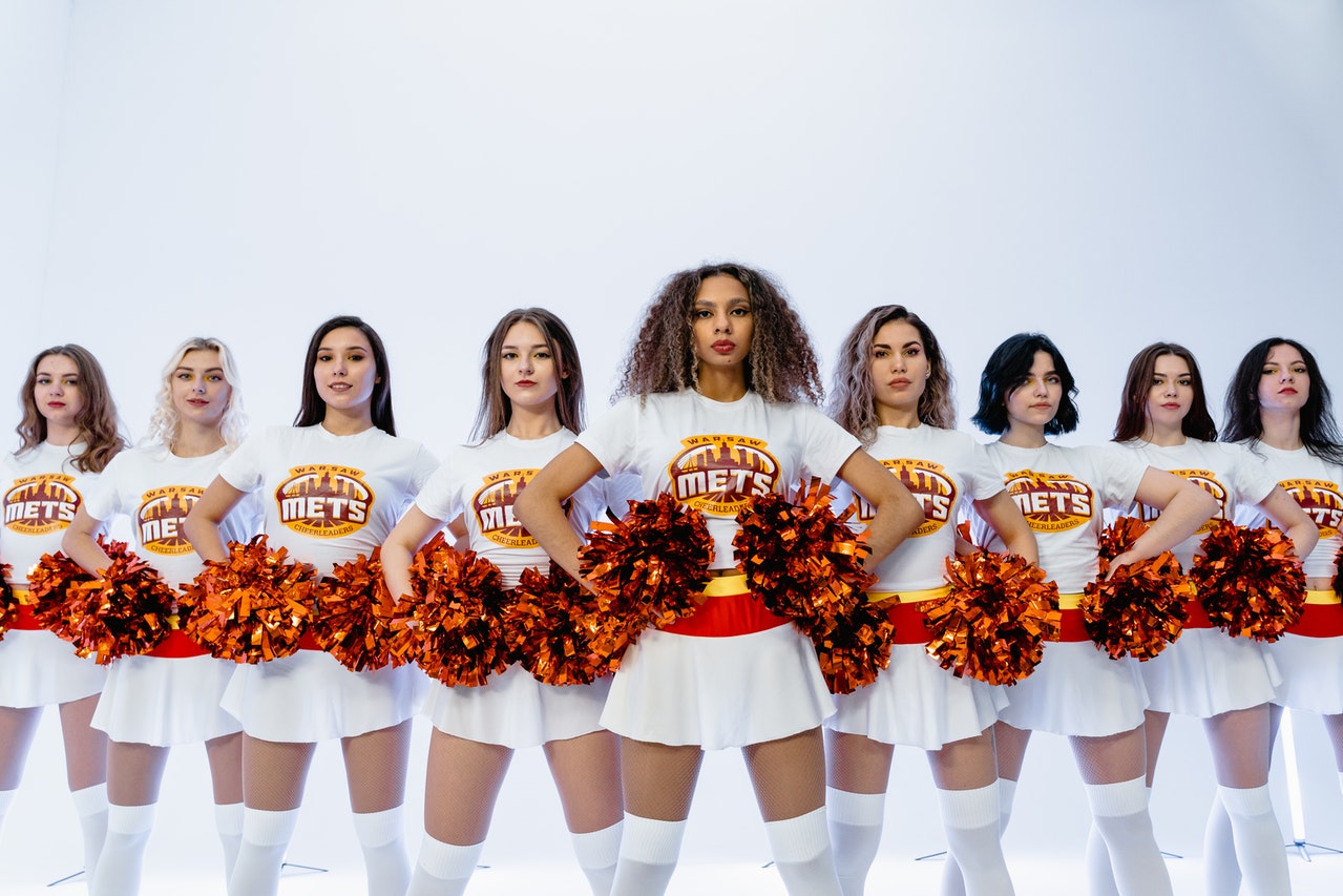 Cheerleader jumping high up in the air