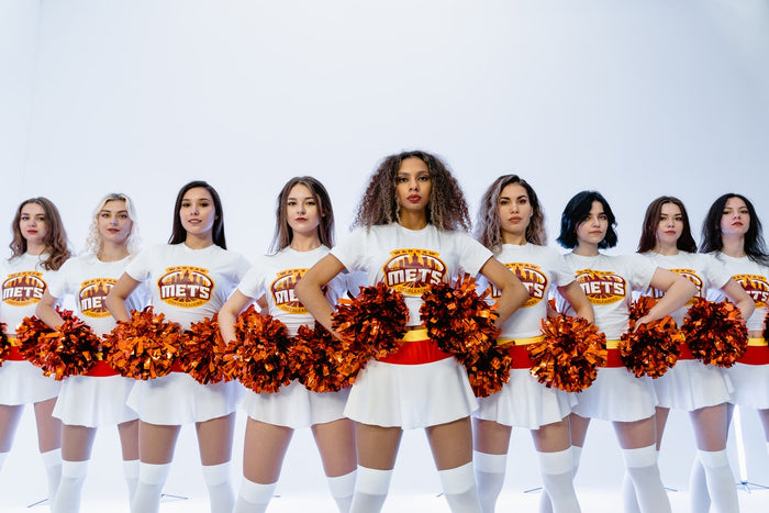Cheerleader jumping high up in the air