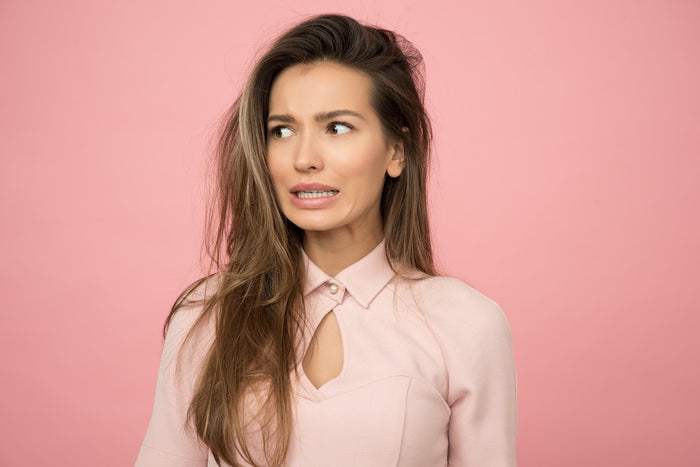 Worried woman wearing a pink top