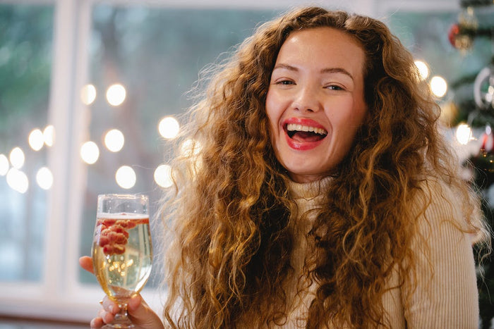 Happy woman holding a glass of bubbly