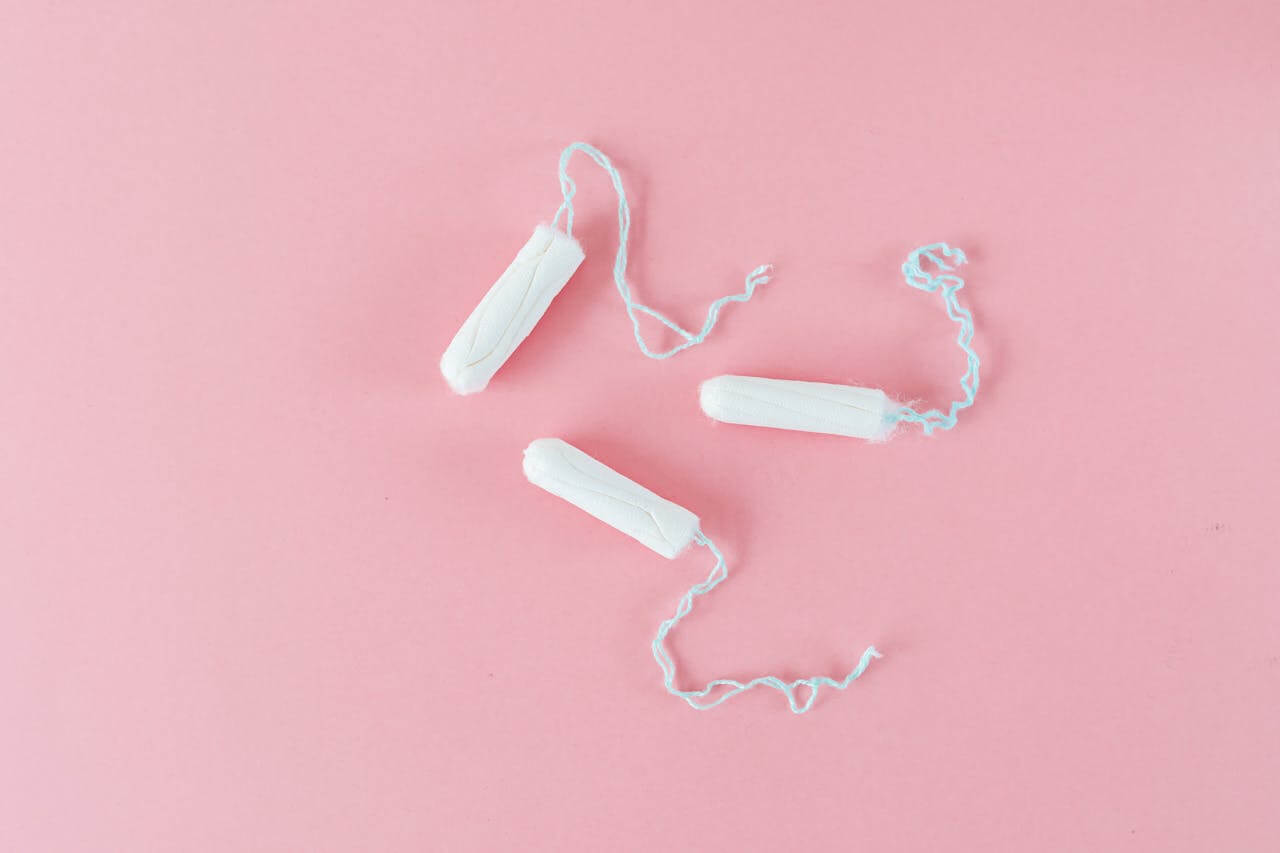 three tampons on a pink background